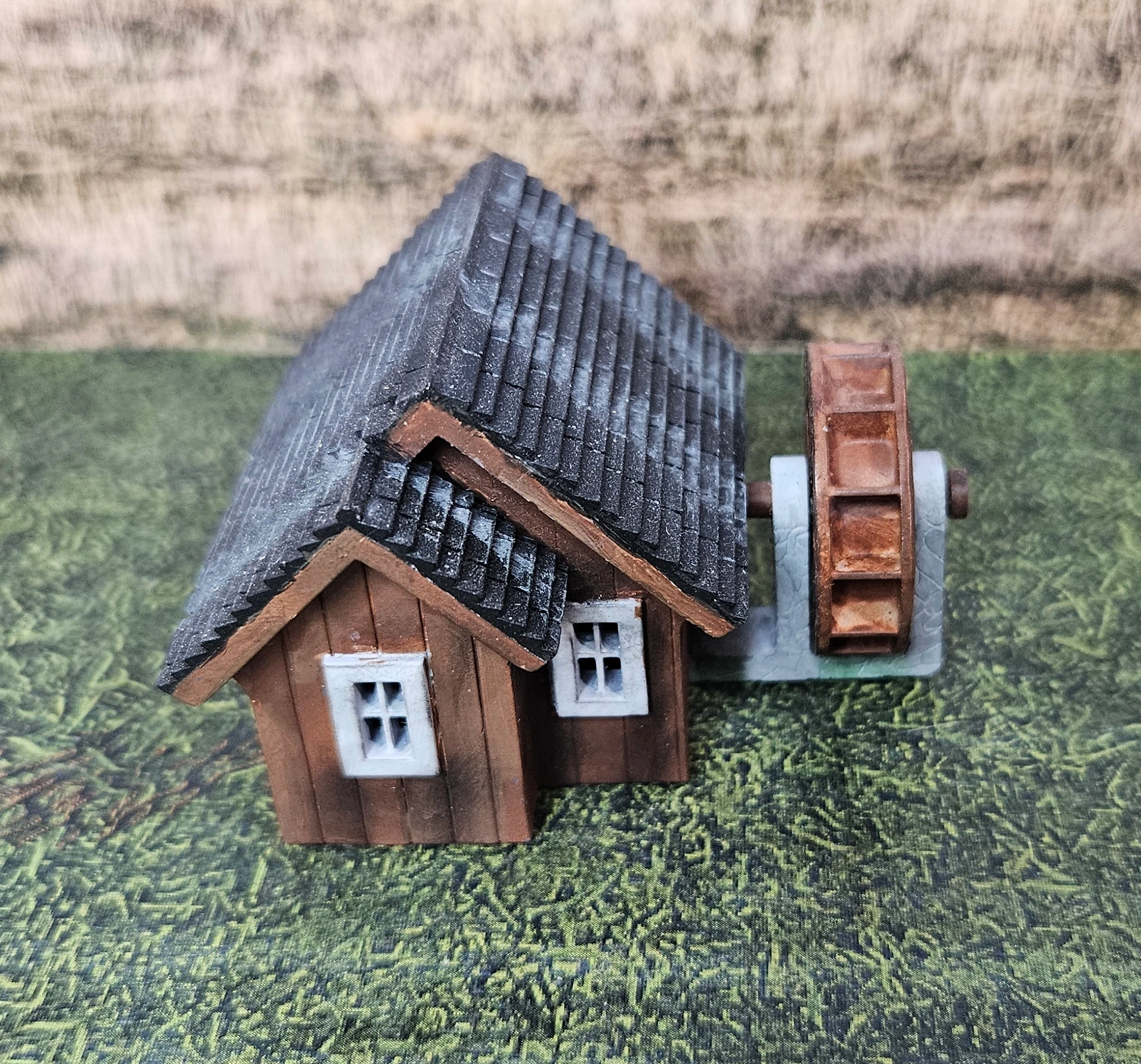 HO scale working waterwheel with a small building