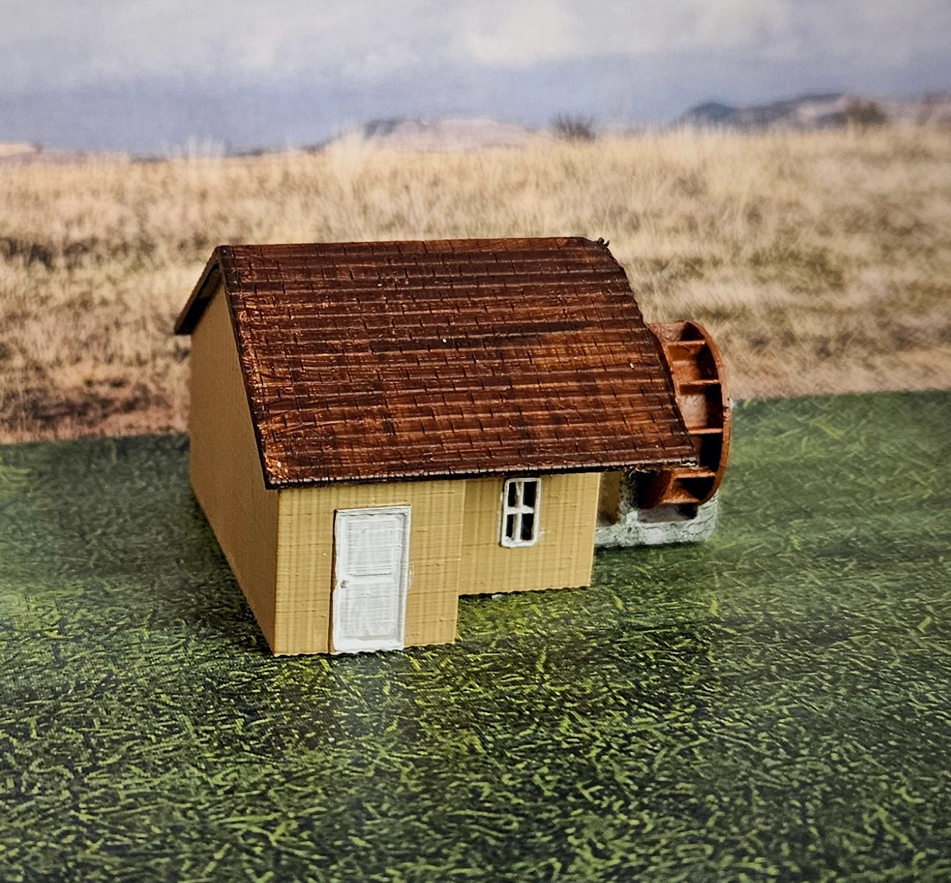 N scale working waterwheel with a large building