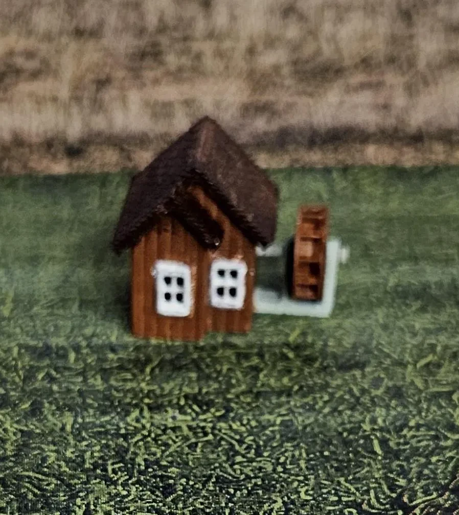 N scale working waterwheel with a small building