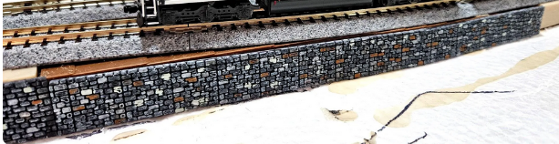Fine stone detail on an N scale model railroad rock wall