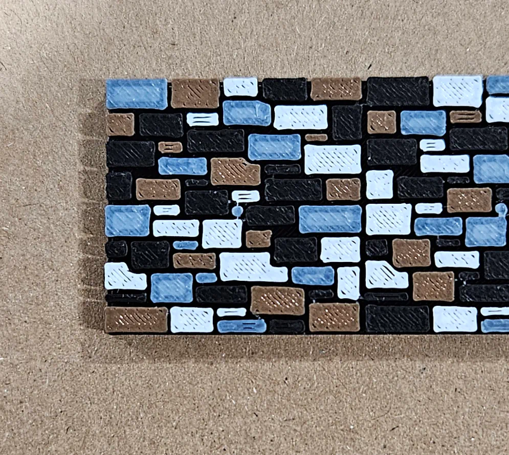 Close view of the charcoal, brown, gray, and light gray stone pattern