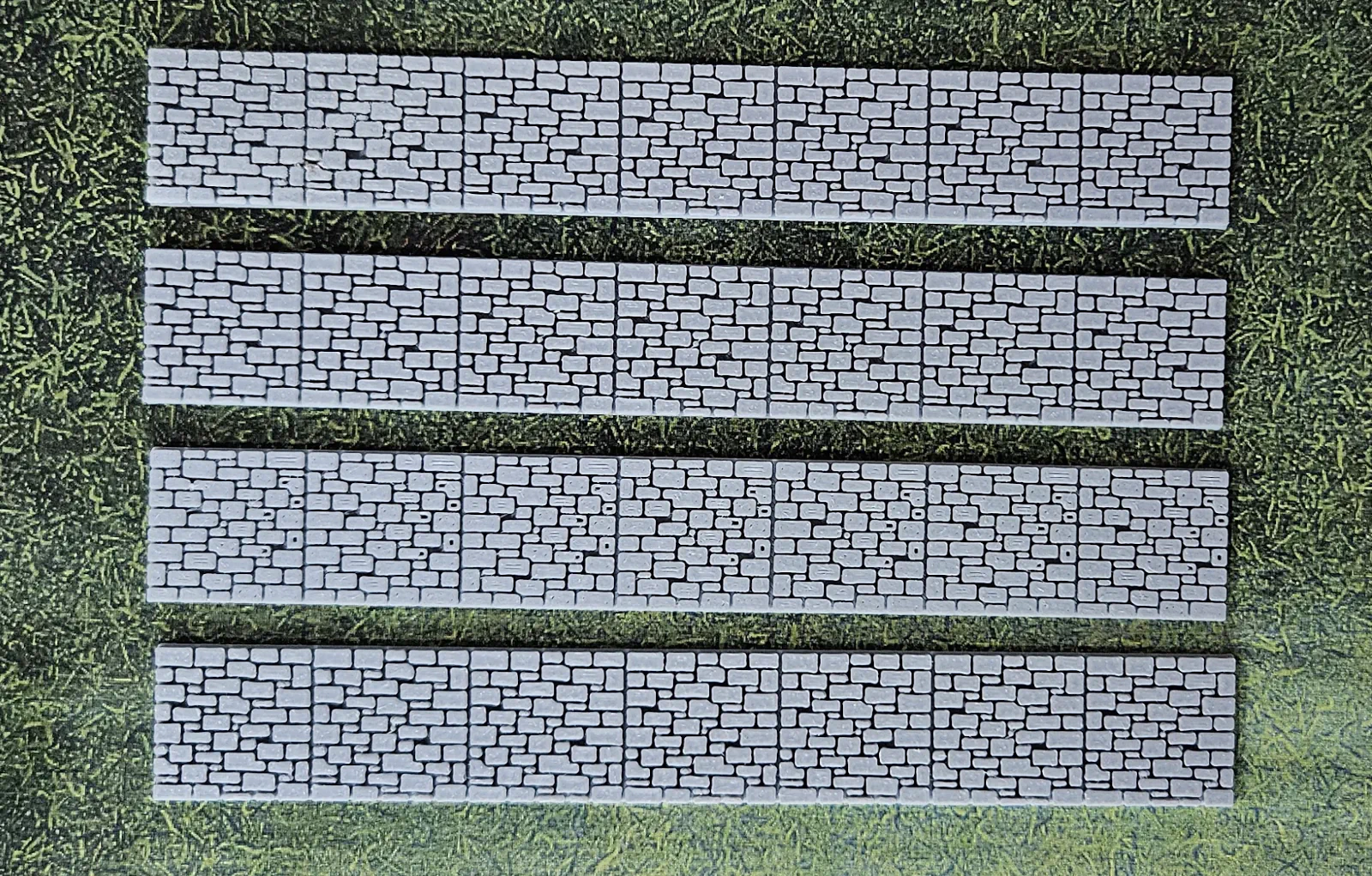 Set of four solid gray HO scale stone wall sections ready for finishing