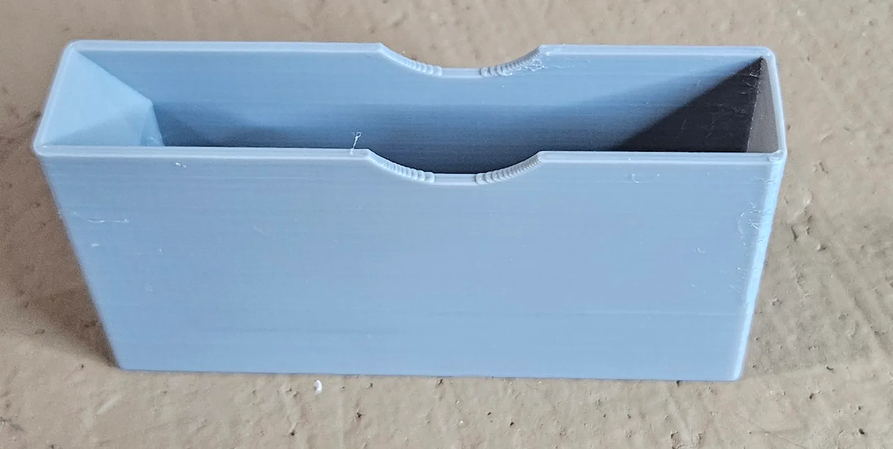 Empty gray protective storage and shipping cover for a locomotive ornament