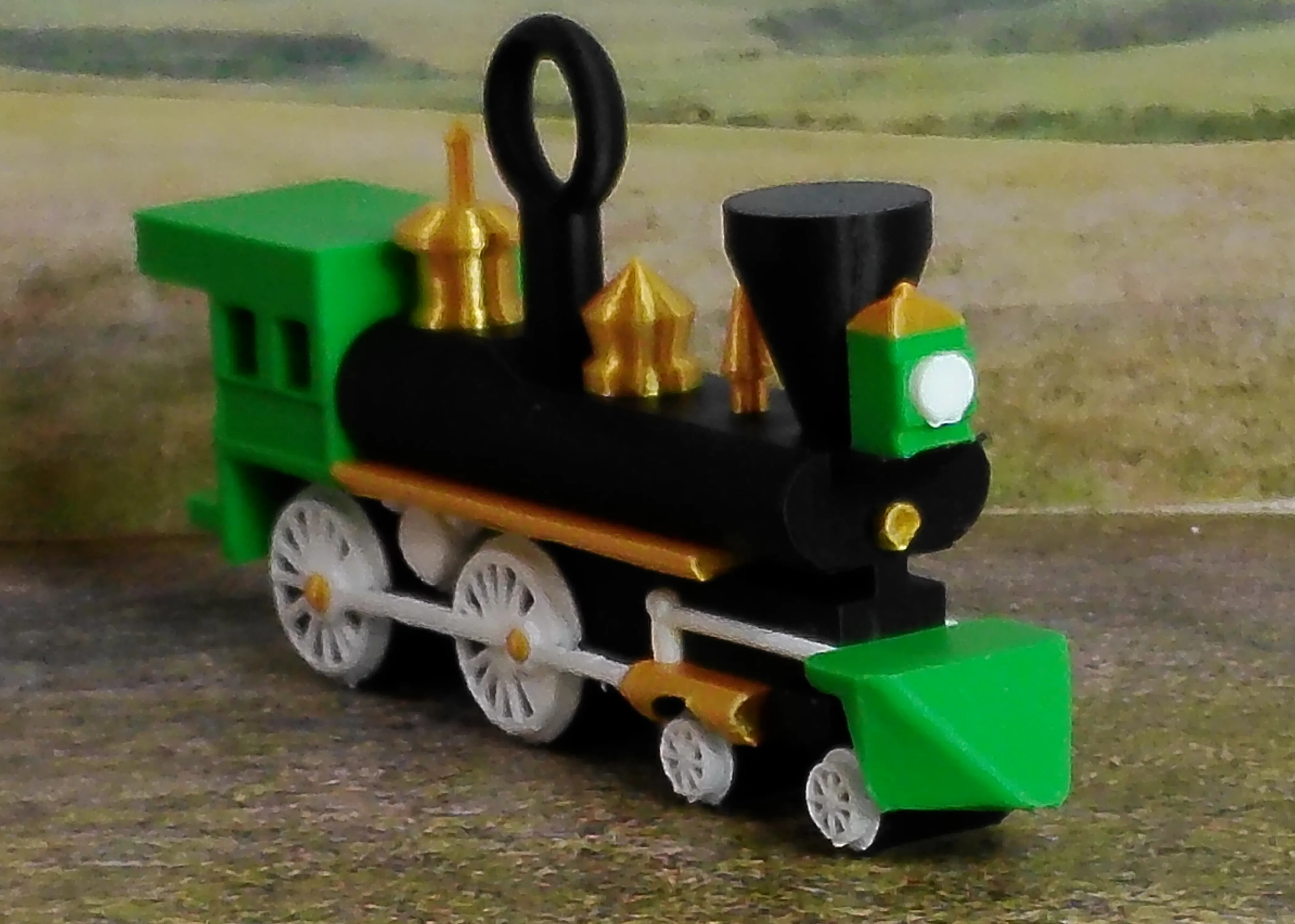 Green steam locomotive Christmas ornament viewed from the front at an angle
