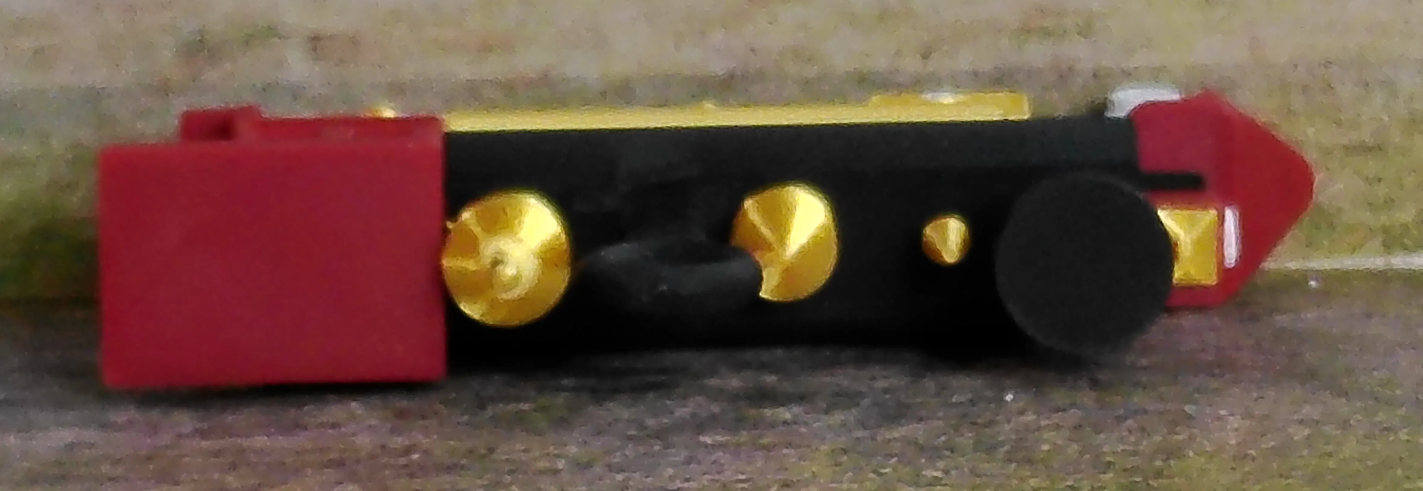 Close view of the red locomotive ornament wheel and running-gear details